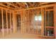Partially insulated interior framing with a fireplace shows the future layout of the living space at 114 Still Creek Dr, Mooresville, NC 28115
