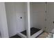 Modern shower with white subway tile, dark shower floor, and a seamless glass enclosure at 118 Still Creek Dr, Mooresville, NC 28115