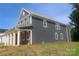 Angle view of the two-story home with gray siding and a covered porch with white columns at 118 Still Creek Dr, Mooresville, NC 28115