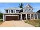 New two-story home with a two car garage and a covered front porch with classic white columns at 118 Still Creek Dr, Mooresville, NC 28115