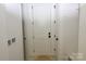 Hallway featuring a white door with black hardware and white trim at 118 Still Creek Dr, Mooresville, NC 28115