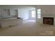 Open-concept living space with kitchen island and a fireplace ready for finishing touches at 118 Still Creek Dr, Mooresville, NC 28115