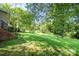 Lush backyard with mature trees and green grass at 1224 Hollywood Ter, Albemarle, NC 28001