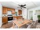 Virtually staged dining area blending a modern dining set with a traditional kitchen featuring wood cabinets at 1224 Hollywood Ter, Albemarle, NC 28001