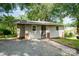 Cozy residence displaying light siding and brick accents, complemented by a tidy walkway and gravel driveway at 1224 Hollywood Ter, Albemarle, NC 28001