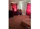 Cozy bedroom with carpet flooring, a window with red curtains and a bed at 124 Powder Sw St, Concord, NC 28025