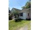 This home features a covered porch and neat landscaping with a charming, inviting curb appeal at 124 Powder Sw St, Concord, NC 28025