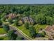 Aerial view of a luxurious home with lush landscaping and a circular driveway at 1377 Shinnecock Ln, Fort Mill, SC 29707