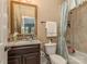 Cozy bathroom with granite counters, decorative mirror, and shower-tub combination at 1377 Shinnecock Ln, Fort Mill, SC 29707
