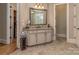 Elegant bathroom vanity with granite countertop, decorative mirror, and neutral color palette offers a relaxing space at 1377 Shinnecock Ln, Fort Mill, SC 29707