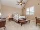 Cozy bedroom with neutral tones, carpet, and natural light from the window provides a peaceful and restful ambiance at 1377 Shinnecock Ln, Fort Mill, SC 29707