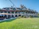 Expansive clubhouse with stone facade, outdoor seating, and stairs leading to upper levels at 1377 Shinnecock Ln, Fort Mill, SC 29707