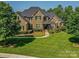 Stunning stone and brick home with lush landscaping and manicured lawn at 1377 Shinnecock Ln, Fort Mill, SC 29707