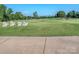 Scenic golf course view with Adirondack chairs overlooking lush green fairway and mature trees at 1377 Shinnecock Ln, Fort Mill, SC 29707