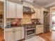 Gourmet kitchen features stainless steel appliances, tile backsplash, and custom cabinetry at 1377 Shinnecock Ln, Fort Mill, SC 29707