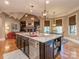 Spacious kitchen island with granite countertop, stainless steel appliances, and dark wood cabinetry at 1377 Shinnecock Ln, Fort Mill, SC 29707