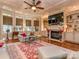 Cozy living room with fireplace, built-in shelving, and large windows at 1377 Shinnecock Ln, Fort Mill, SC 29707