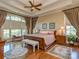Serene main bedroom boasts tray ceilings, hardwood floors, and arched window at 1377 Shinnecock Ln, Fort Mill, SC 29707