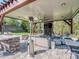 Outdoor living space with fireplace, seating area, grill, and fan for relaxing at 1377 Shinnecock Ln, Fort Mill, SC 29707