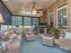 Inviting screened porch featuring cozy seating, ceiling fan, and brick accents at 1377 Shinnecock Ln, Fort Mill, SC 29707