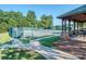 Well-maintained tennis courts with covered seating area and lush green surroundings at 1377 Shinnecock Ln, Fort Mill, SC 29707