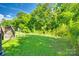 Large backyard with green grass and treeline at 13916 Mallard Lake Rd, Charlotte, NC 28262