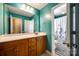 Well lit bathroom with wood cabinets and tile floor at 13916 Mallard Lake Rd, Charlotte, NC 28262