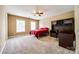 Large bedroom features a fan, carpet, and built-in desk at 13916 Mallard Lake Rd, Charlotte, NC 28262