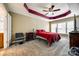 Bedroom with neutral carpet, red accent paint, ceiling fan and lots of natural light from windows at 13916 Mallard Lake Rd, Charlotte, NC 28262