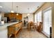 Cozy kitchen featuring warm wood cabinetry, tiled floors, and a dining area with ample natural light at 13916 Mallard Lake Rd, Charlotte, NC 28262