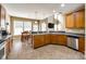 Bright kitchen features tile floors, granite countertops, stainless steel appliances, and an adjacent dining area at 13916 Mallard Lake Rd, Charlotte, NC 28262