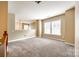 Spacious and bright living room with carpet flooring and multiple windows for natural light at 13916 Mallard Lake Rd, Charlotte, NC 28262