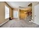 Inviting living room featuring neutral tones, plush carpeting, and a staircase leading to the upper level at 13916 Mallard Lake Rd, Charlotte, NC 28262