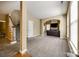 Spacious living room with plush carpeting, neutral tones, and an archway leading to another room at 13916 Mallard Lake Rd, Charlotte, NC 28262