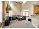 Open-concept living room with high ceilings, plush seating, and a modern media center at 13916 Mallard Lake Rd, Charlotte, NC 28262