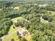 Expansive aerial view of wooded acreage with single Gathering home and pool at 157 Fraley Rd, Gastonia, NC 28052