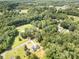 Expansive aerial view of wooded acreage with single Gathering home and pool at 157 Fraley Rd, Gastonia, NC 28052