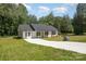 Well-maintained home with a gray roof, a long driveway, and mature trees in a lush setting at 157 Fraley Rd, Gastonia, NC 28052