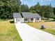 Charming single story home with white siding, black shutters, and a long drive way at 157 Fraley Rd, Gastonia, NC 28052