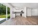 Modern kitchen featuring white cabinetry, stainless steel appliances, and a sliding glass door to the backyard at 157 Fraley Rd, Gastonia, NC 28052