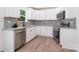 Modern kitchen featuring stainless steel appliances, granite countertops, and sleek white cabinetry at 157 Fraley Rd, Gastonia, NC 28052