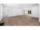 Spacious, naturally lit living room featuring modern flooring and a sliding barn door to the exterior at 157 Fraley Rd, Gastonia, NC 28052