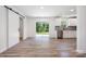 Bright living space featuring modern floors, large windows, and a sliding barn door to the kitchen at 157 Fraley Rd, Gastonia, NC 28052