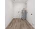 Utility room features a hot water heater, wood-look floors, and white walls at 157 Fraley Rd, Gastonia, NC 28052