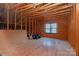 Unfinished attic space with exposed wooden beams and small window at 16016 Reynolds Dr, Fort Mill, SC 29707