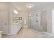 Bright bathroom with a glass-enclosed shower, tile flooring, and a white vanity with double sinks at 16016 Reynolds Dr, Fort Mill, SC 29707