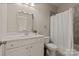 Modern bathroom featuring a white vanity, a stylish mirror and a shower with white curtain at 16016 Reynolds Dr, Fort Mill, SC 29707
