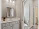 Bright bathroom featuring a vanity with double sinks and a toilet behind a door at 16016 Reynolds Dr, Fort Mill, SC 29707