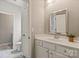 Bathroom with a granite countertop sink vanity, framed mirror, and nearby toilet at 16016 Reynolds Dr, Fort Mill, SC 29707