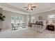 Serene primary bedroom with tray ceiling, sitting area, and large windows providing ample natural light at 16016 Reynolds Dr, Fort Mill, SC 29707